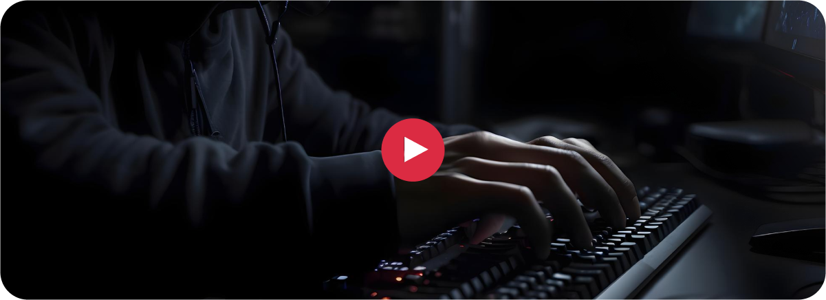 Person typing on a keyboard in a dark room